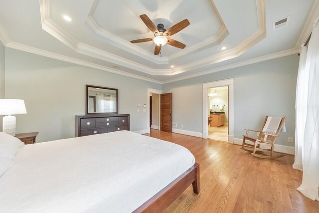 bedroom featuring a raised ceiling, ceiling fan, crown molding, and light hardwood / wood-style flooring