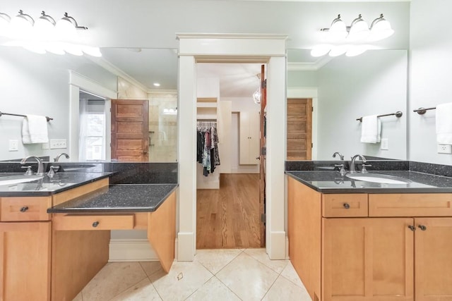 bathroom featuring vanity, tile patterned floors, walk in shower, and ornamental molding