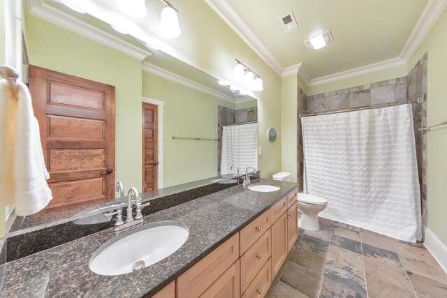 bathroom featuring walk in shower, crown molding, vanity, and toilet