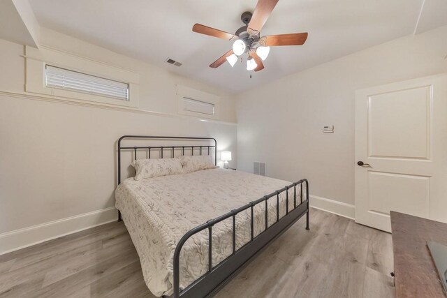 bedroom with ceiling fan and light wood-type flooring