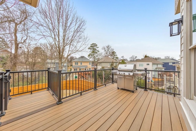 wooden terrace featuring a grill