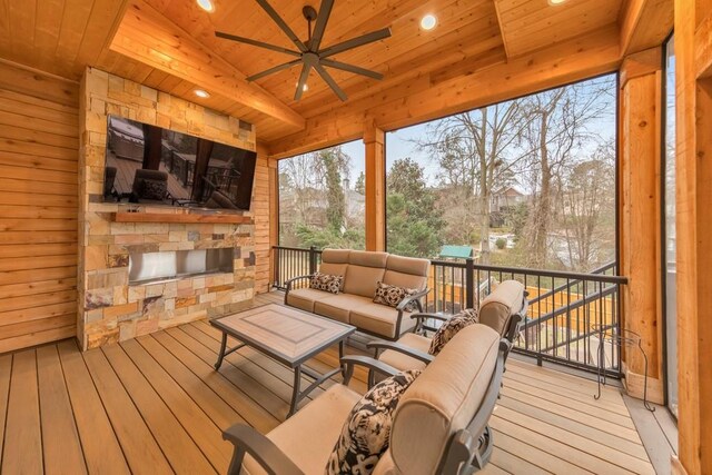 sunroom / solarium with ceiling fan, lofted ceiling, and wood ceiling