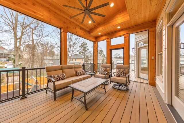 sunroom / solarium featuring lofted ceiling, ceiling fan, and wooden ceiling