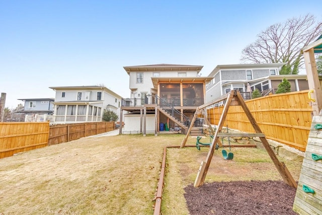 exterior space featuring a playground, a sunroom, and a lawn