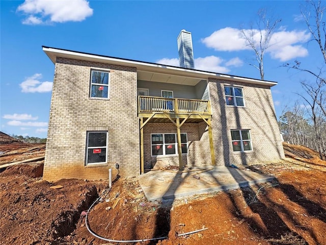 back of property with a patio area and a balcony