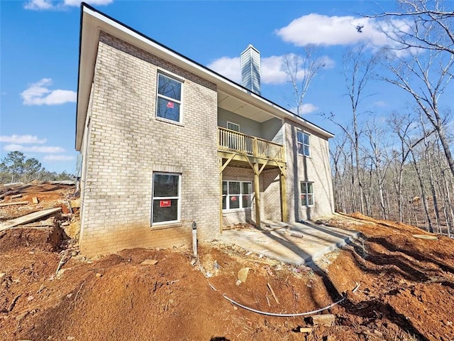 rear view of house with a patio area and a balcony