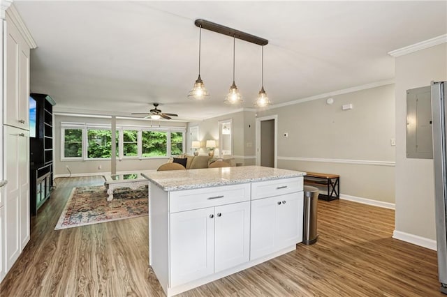 208 Hembree Park Ter, Roswell, GA 30076 - kitchen featuring white cabinetry, crown molding, wood finished floors, ceiling fan, and a kitchen island