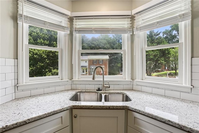 208 Hembree Park Ter, Roswell, GA 30076 - kitchen featuring decorative backsplash, plenty of natural light, and light stone countertops