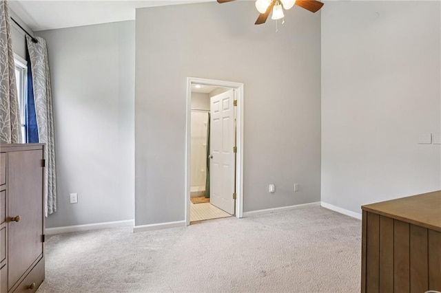 208 Hembree Park Ter, Roswell, GA 30076 - unfurnished bedroom featuring carpet, a ceiling fan, a towering ceiling, and connected bathroom