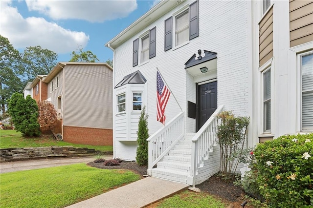 208 Hembree Park Ter, Roswell, GA 30076 - doorway to property featuring a lawn and brick siding