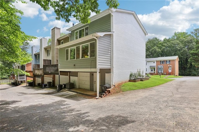 208 Hembree Park Ter, Roswell, GA 30076 - view of front facade featuring an attached garage, driveway, a chimney, and brick siding