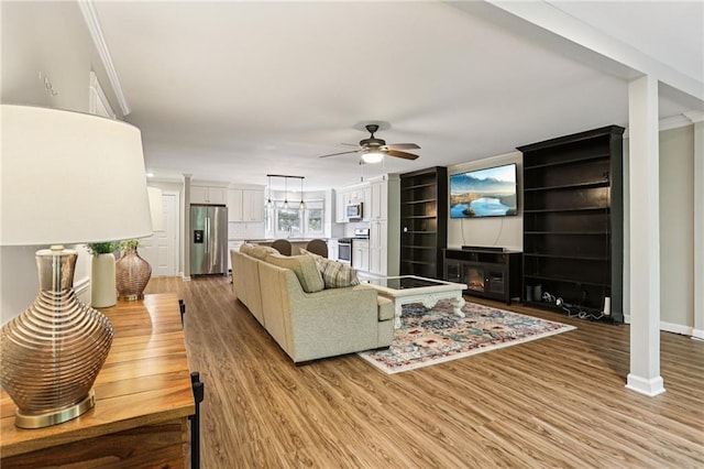 208 Hembree Park Ter, Roswell, GA 30076 - living room with a ceiling fan, light wood finished floors, and crown molding