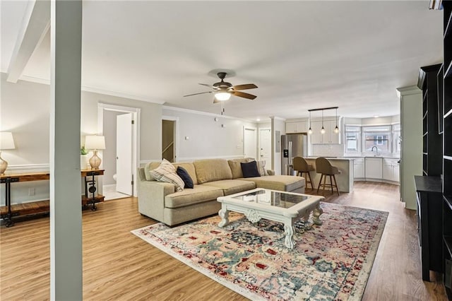208 Hembree Park Ter, Roswell, GA 30076 - living room with light wood finished floors, ceiling fan, and crown molding