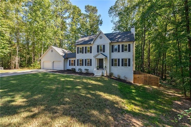 colonial-style house with a front yard and a garage