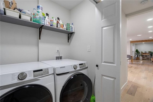 laundry room featuring light hardwood / wood-style floors and independent washer and dryer