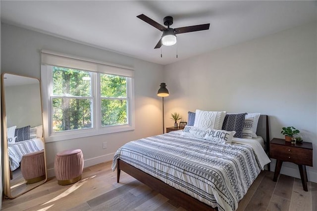 bedroom featuring hardwood / wood-style flooring and ceiling fan