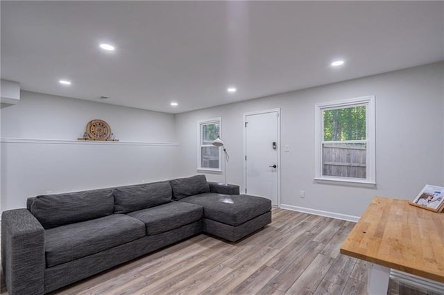 living room with plenty of natural light and light hardwood / wood-style floors