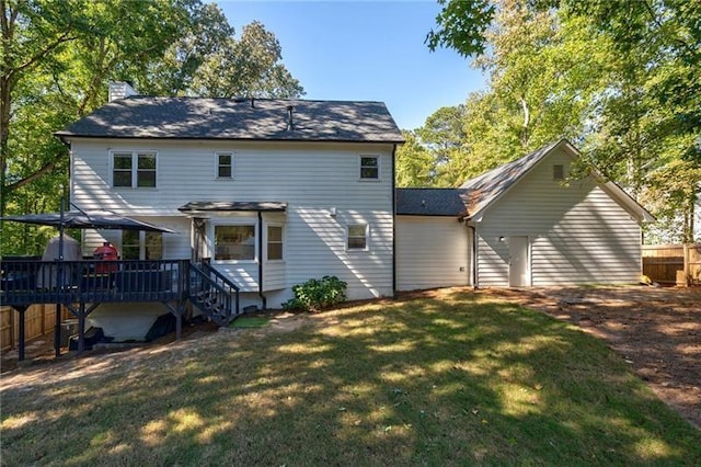 back of property with a pergola, a yard, and a wooden deck