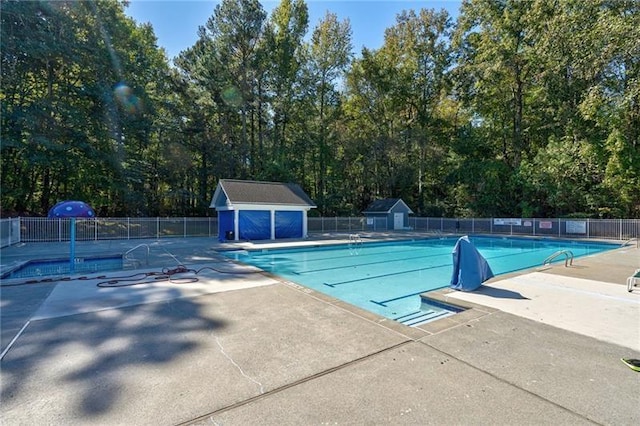 view of swimming pool featuring an outbuilding and a patio area