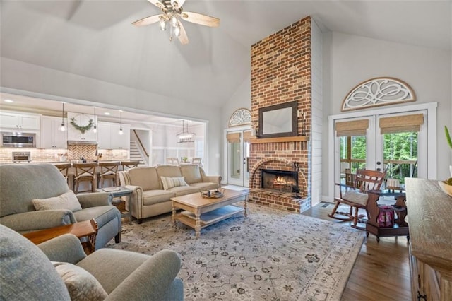 726 Swilling Rd, Eastanollee, GA 30538 - living area featuring high vaulted ceiling, wood finished floors, a ceiling fan, a fireplace, and stairs