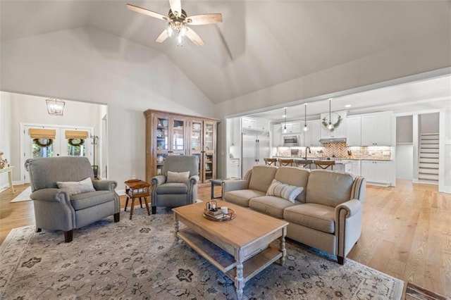 726 Swilling Rd, Eastanollee, GA 30538 - living room featuring light wood-style flooring, ceiling fan, high vaulted ceiling, and french doors
