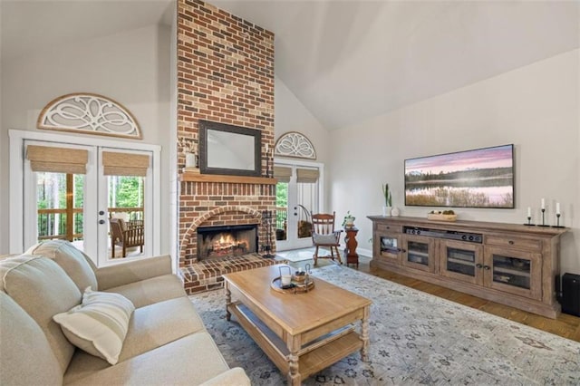 726 Swilling Rd, Eastanollee, GA 30538 - living room with high vaulted ceiling, french doors, a fireplace, plenty of natural light, and wood finished floors