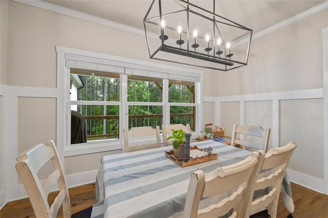 726 Swilling Rd, Eastanollee, GA 30538 - dining area with crown molding, plenty of natural light, wood finished floors, a chandelier, and a decorative wall