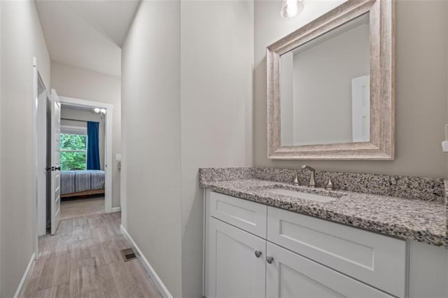 726 Swilling Rd, Eastanollee, GA 30538 - bathroom featuring baseboards, vanity, and wood finished floors