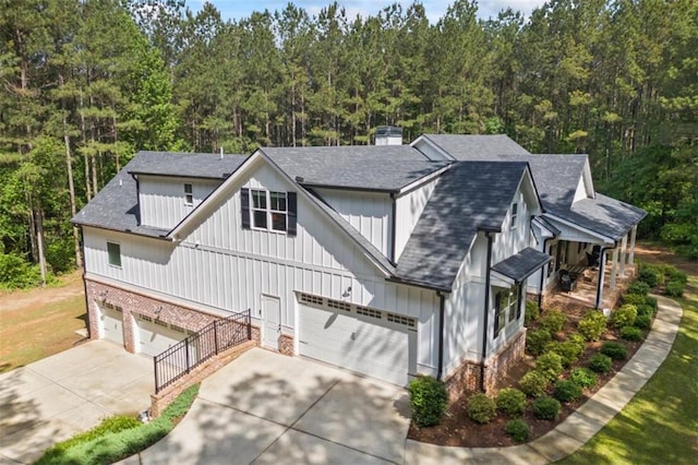 726 Swilling Rd, Eastanollee, GA 30538 - view of front facade featuring driveway, board and batten siding, a shingled roof, and a garage