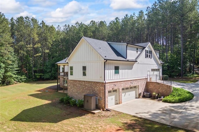 726 Swilling Rd, Eastanollee, GA 30538 - view of home's exterior featuring brick siding, concrete driveway, an attached garage, a lawn, and board and batten siding