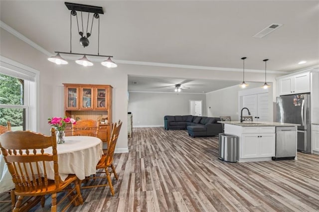 726 Swilling Rd, Eastanollee, GA 30538 - dining area with crown molding, a ceiling fan, wood finished floors, and baseboards