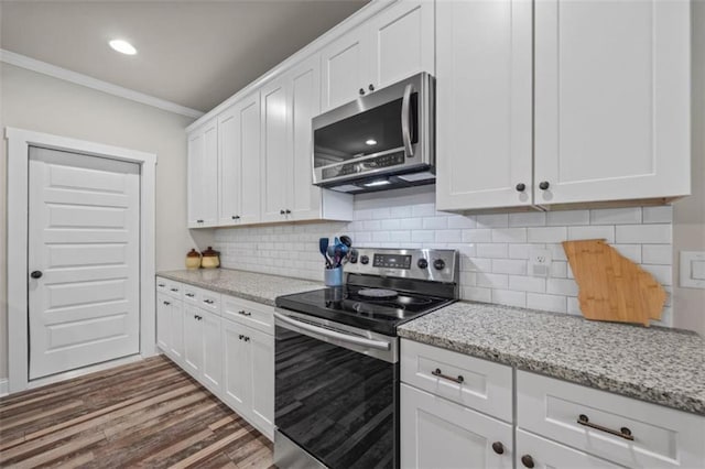726 Swilling Rd, Eastanollee, GA 30538 - kitchen featuring appliances with stainless steel finishes, ornamental molding, white cabinetry, light stone countertops, and recessed lighting