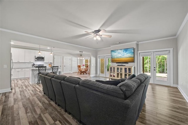 726 Swilling Rd, Eastanollee, GA 30538 - living area with dark wood-type flooring, baseboards, a ceiling fan, ornamental molding, and french doors