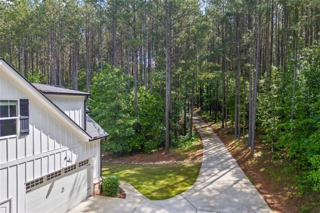 726 Swilling Rd, Eastanollee, GA 30538 - view of yard with a garage, a wooded view, and driveway