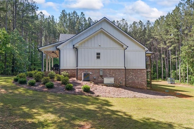 726 Swilling Rd, Eastanollee, GA 30538 - view of side of property featuring a yard, board and batten siding, central AC, and a wooded view