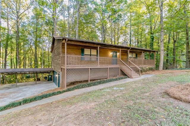 view of front of house with a porch and a carport