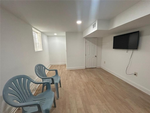 bedroom with hardwood / wood-style floors and wooden walls