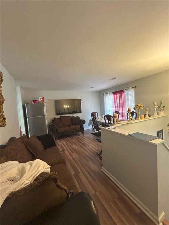 dining room with dark hardwood / wood-style floors and a notable chandelier