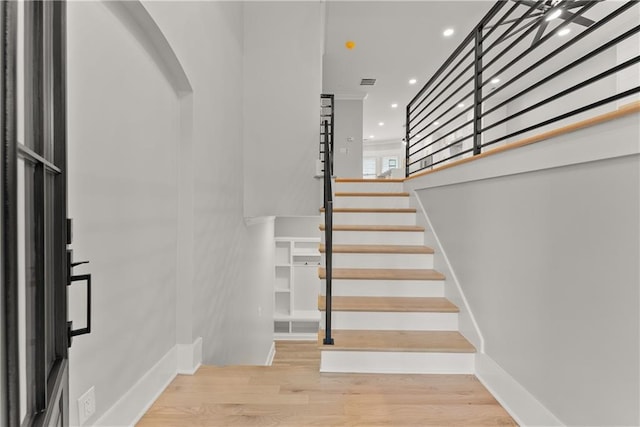 3932 Boston Common St, Suwanee, GA 30024 - staircase with arched walkways, recessed lighting, wood finished floors, and baseboards