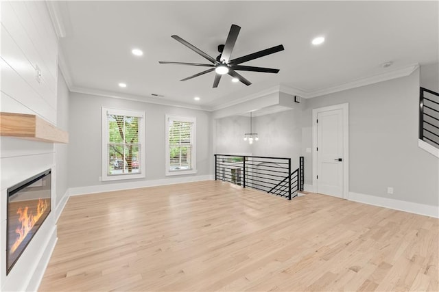 3932 Boston Common St, Suwanee, GA 30024 - unfurnished living room with crown molding, light wood-style floors, ceiling fan, a fireplace, and recessed lighting