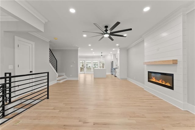 3932 Boston Common St, Suwanee, GA 30024 - unfurnished living room featuring ornamental molding, recessed lighting, ceiling fan, light wood-type flooring, and a fireplace