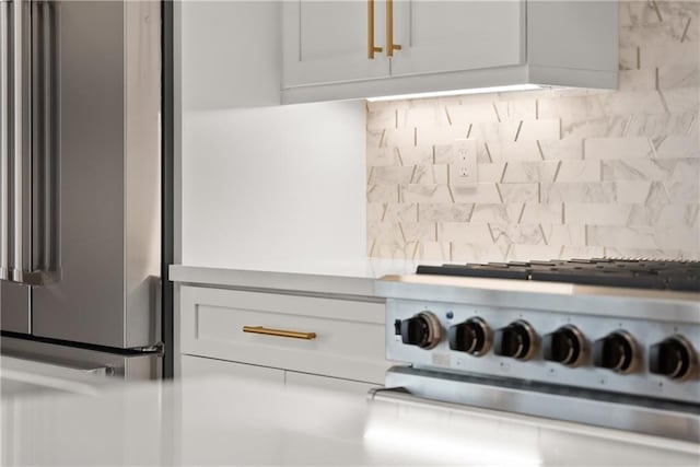 3932 Boston Common St, Suwanee, GA 30024 - kitchen view of freestanding refrigerator, decorative backsplash, range with gas stovetop, light countertops, and white cabinets