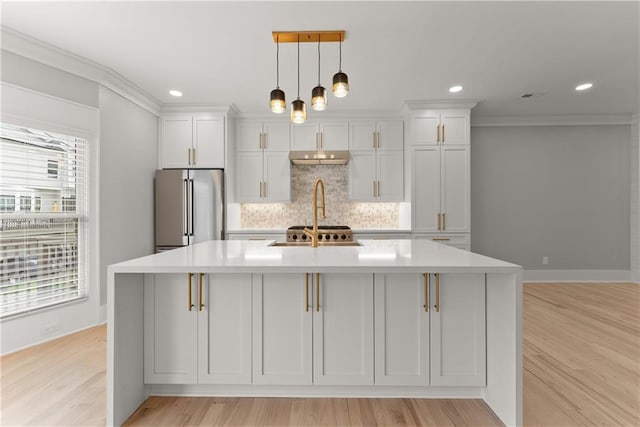 3932 Boston Common St, Suwanee, GA 30024 - kitchen with stainless steel refrigerator, backsplash, light countertops, a kitchen island with sink, and white cabinetry