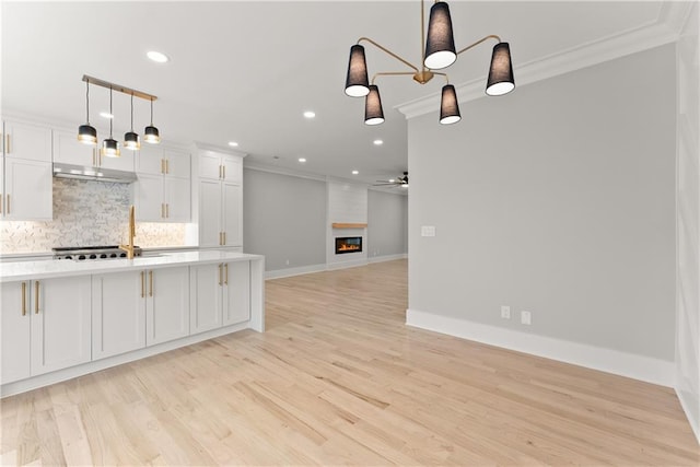 3932 Boston Common St, Suwanee, GA 30024 - kitchen with crown molding, light countertops, decorative backsplash, recessed lighting, and white cabinetry