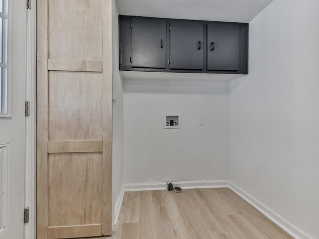 laundry area featuring hardwood / wood-style flooring, cabinets, and hookup for a washing machine