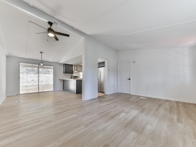 unfurnished living room featuring ceiling fan, light hardwood / wood-style floors, and vaulted ceiling