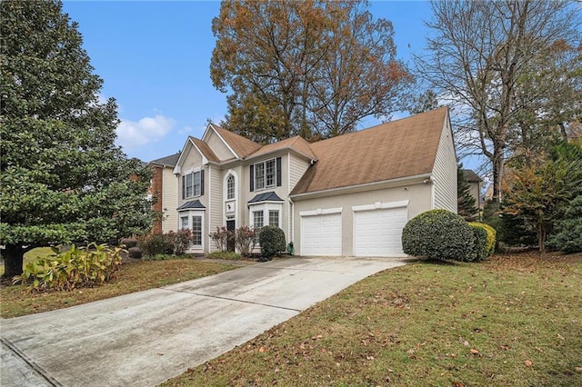 view of front property featuring a front lawn and a garage