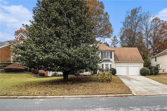 obstructed view of property with a front yard and a garage