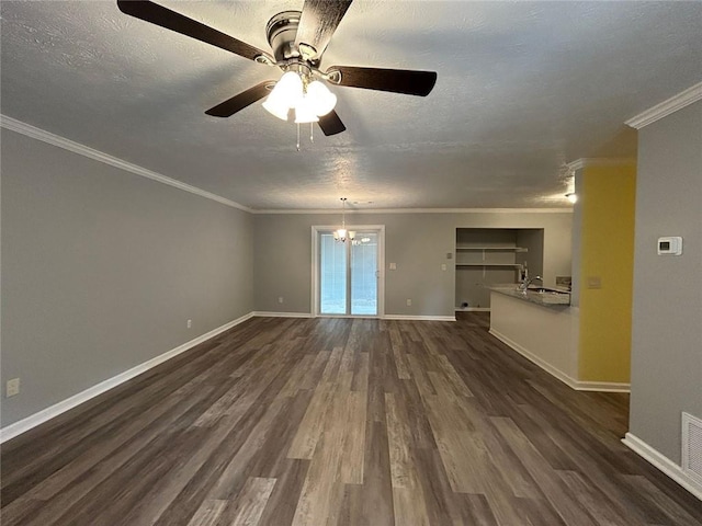 spare room with dark wood-type flooring, crown molding, sink, and a textured ceiling