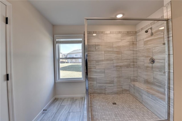 bathroom featuring a shower with door